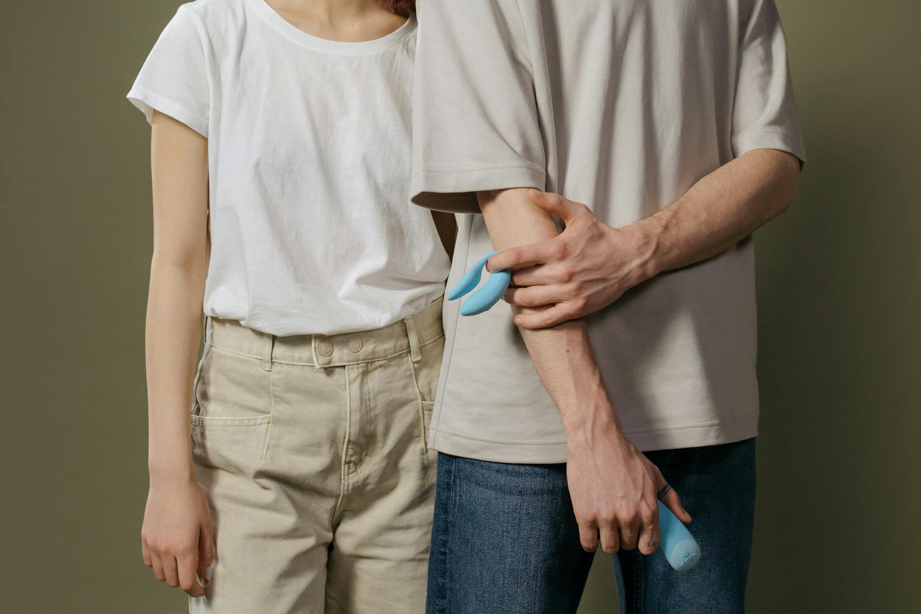 A couple standing together indoors, rebuilding emotional and physical connection after conflict.